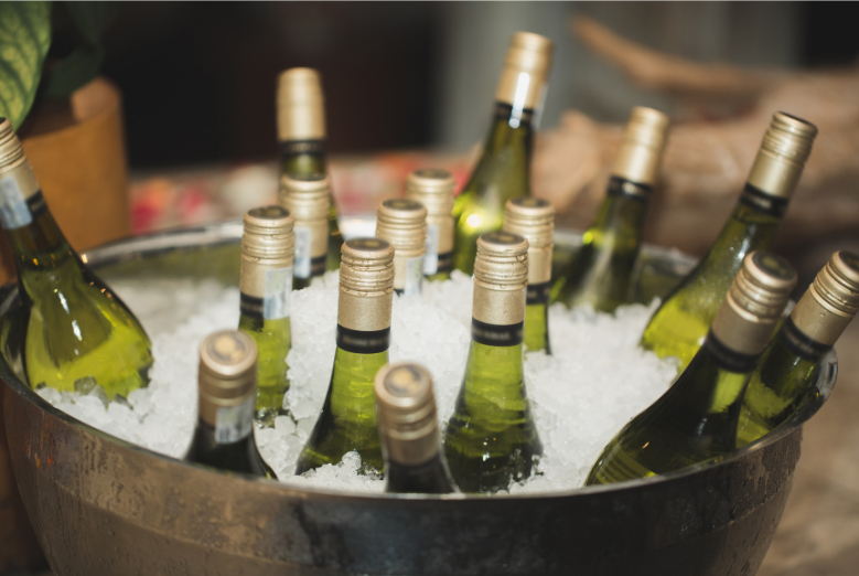 wine bottles in a steel bucket in ice